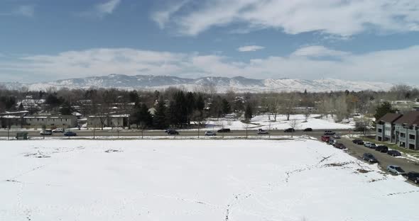 A wide pan shot of the rocky mountains from Fort Collins Colorado showing snowfall March 2021