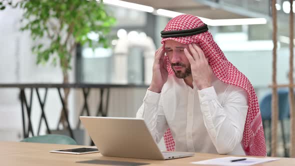 Stressed Arab Businessman with Laptop Having Headache 