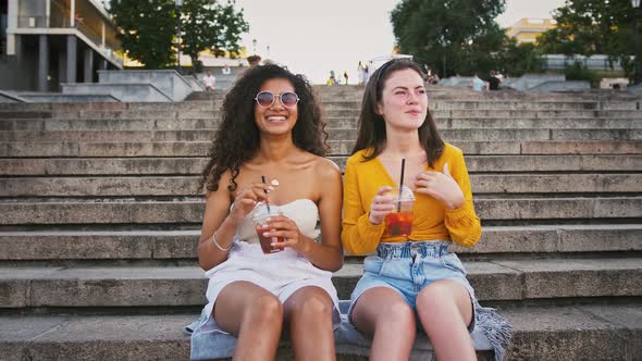 Two Young Women are Holding Cold Drinks