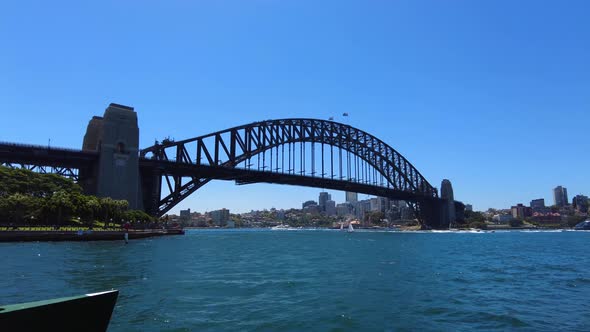 Tracking shot towards Sydney Harbour Bridge on a sunny day