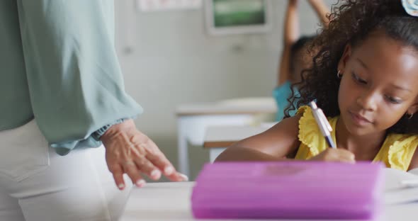 Video of african american girl doing lessons in classroom