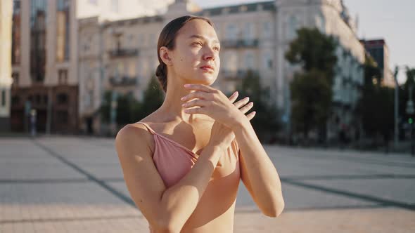 Ballet Dancer Shows Graceful Movements with Hands at Sunrise