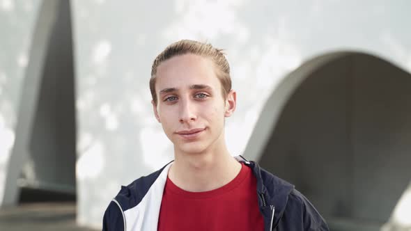 Portrait of Blond Teenager Boy Smiling and Looking at Camera with Positive Emotion Enjoying