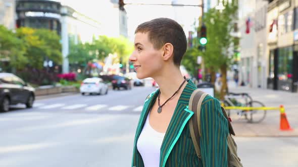 Woman in the city next to a busy road