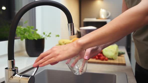 Woman Pouring Water in Glass