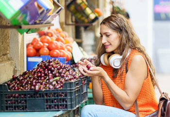 Woman buying ecological organic cherries in the shop