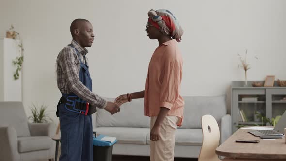 African-American Woman Telling Carpenter What to Do