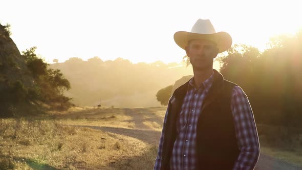 Cinematic shot of cowboy standing strong with beautiful lighting behind him