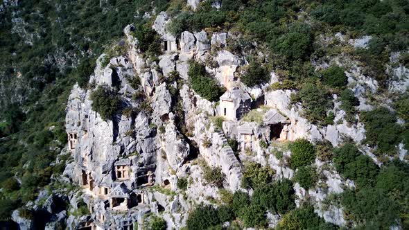 High angle drone aerial view of ancient greek rock cut lykian empire amphitheatre and tombs in Myra