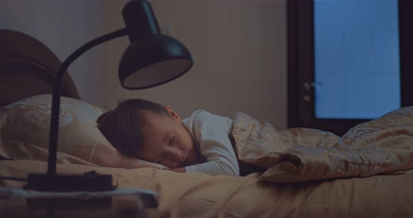 Sleeping Baby Is Happy and Carefree in His Bed