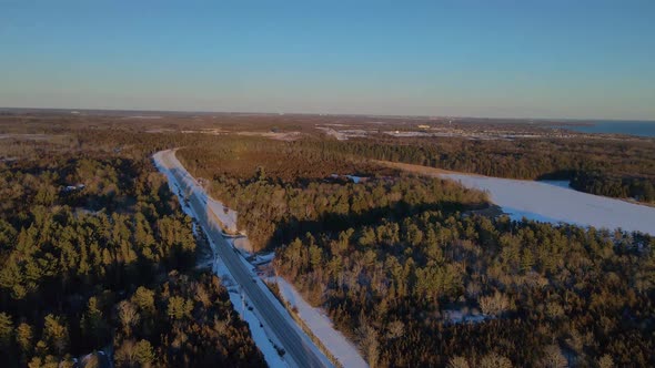 aerial sunset going down over a winter landscape