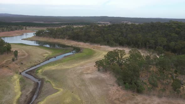 Aerial footage of a large fresh water reservoir being challenged by drought in regional Australia