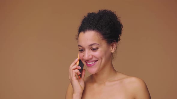 Beauty Portrait of Young African American Woman Talks on Mobile Phone and is Happy