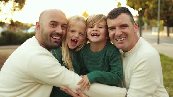 LGBT Family Outdoor  Happy Gay Men Fathers and Sons Having Fun Together at City Park