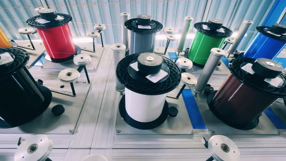 Bottom View of Several Colorful Spinning Spools Stored on the Panel