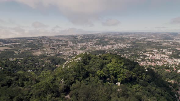 Dolly in shot capturing the vast expanse of Sintra mountaintop landscape with Castelo dos Mouros.