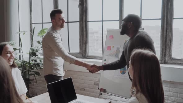 Congratulations with Your Promotion! Two Men, Black and White Guy Shaking Hands and Smiling While