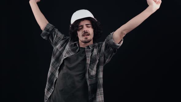 Sleepy Hipster Lies with His Hands Up Then Helmet Looking Into the Room Bored