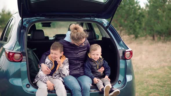 Kid Having Fun. Carefree Mom Preschool Sons Enjoy Activity Adventure. Son Boys Sitting Car Trunk.