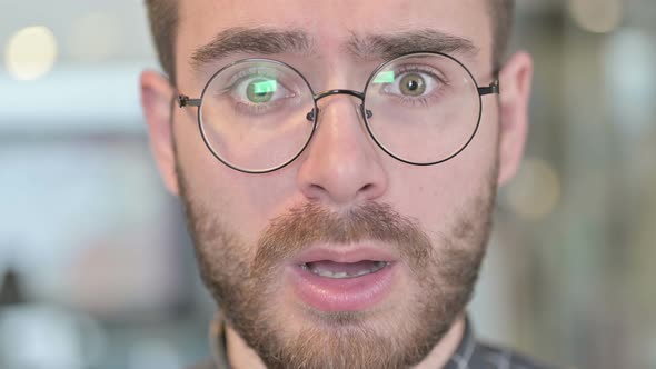 Close Up Of Disappointed Young Man Shaking Head at Camera