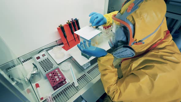 Chemical Analysis Is Being Done By a Specialist in a Hazmat Suit
