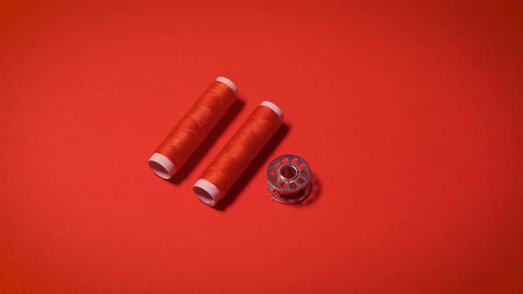 Threads and Zipper on a Red Minimalistic Background