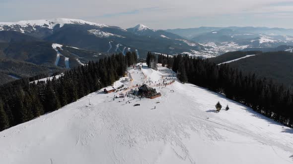 Aerial Ski Slopes with Skiers and Ski Lifts on Ski Resort. Snowy Mountain Forest