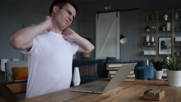 Man with Neck Pain working on Laptop