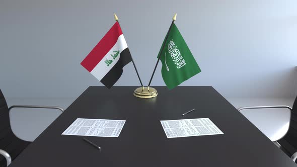 Flags of Iraq and Saudi Arabia on the Table