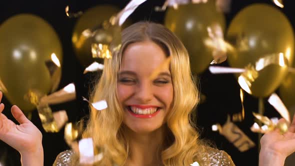 Happy Blond Woman Standing Under Falling Confetti, Enjoying Party, Celebration