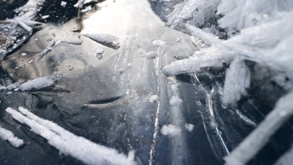 Camera Moves Slowly Over the Ice Surface of Frozen River