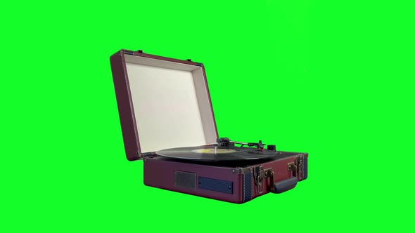 A Retro Portable Turntable Isolated on Green Background. 4K.