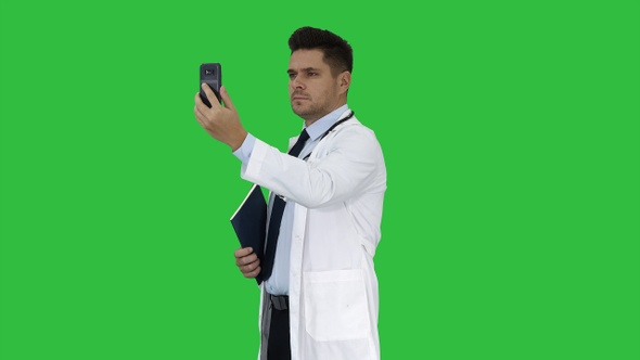 Male doctor making a video call talking to his patient