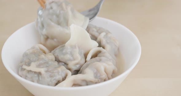 Eating chinese soup meat dumpling 