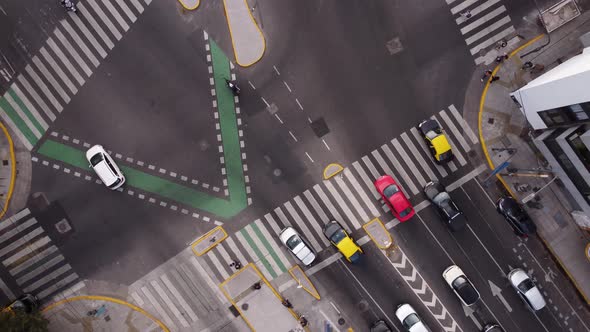 Ascending aerial top down of traffic on splitting road in Buenos Aires during rush hour time - orbit