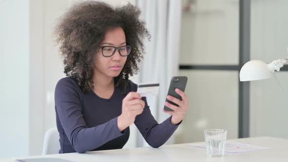 African Woman Excited By Successful Online Shopping on Smartphone