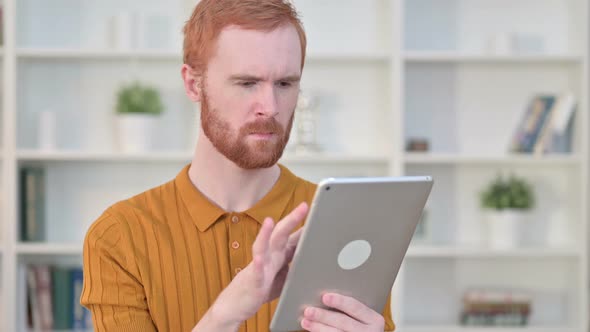 Portrait of Attractive Redhead Man Using Tablet