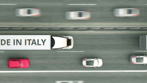 Trucks with MADE IN ITALY Text Driving Along the Road