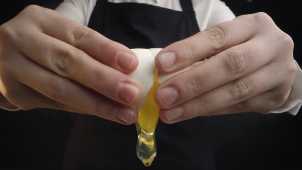 A Cook Is Breaking an Egg
