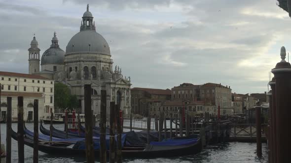 Docked Gondolas Rocking Among Poles, Historical Cathedral Facing Channel 