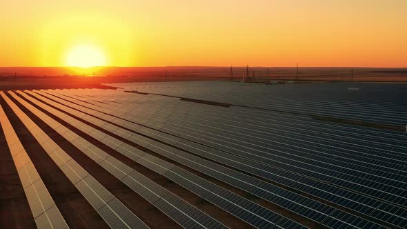 Top View of a Massive Photovoltaic Power Station at Sunset