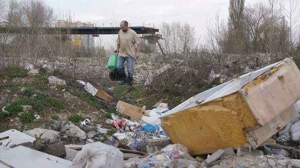 Mature Male Scavenging for Plastic at Trash Site