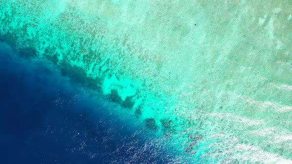 Tropical drone island view of a white sand paradise beach and aqua blue water background in colourfu