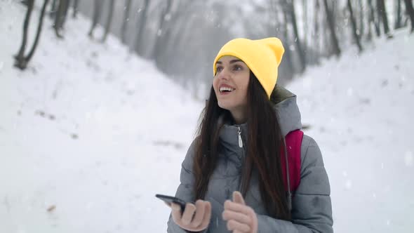 Girl with Backpack Using Smartphone Gps