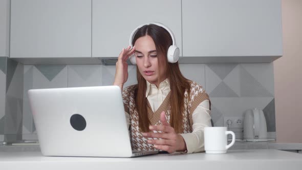 Video Footage of a Young Woman Using a Headset and Computer in a Modern Office