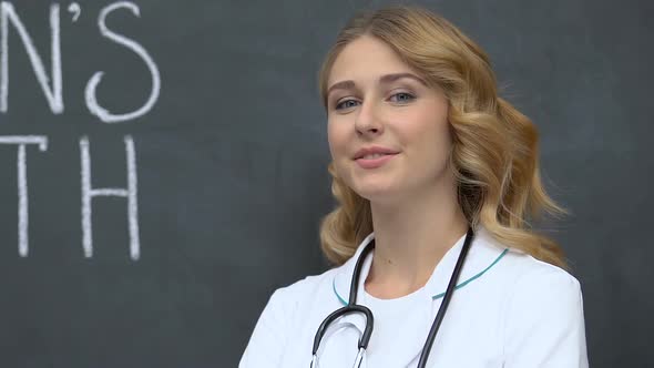 Attractive Female Doctor Standing and Smiling to Cam, Womans Health Protection