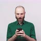 Handsome bearded man surprized and shocked using mobile phone over white background. - VideoHive Item for Sale