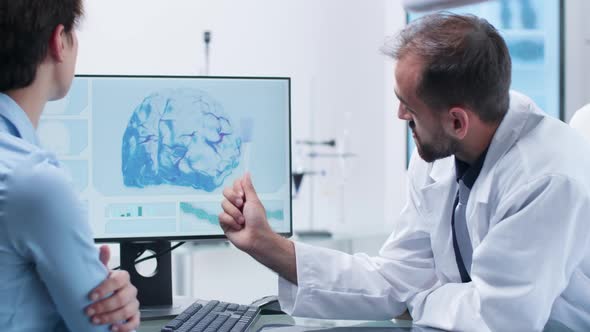 Caucasian Scientist in White Medical Uniform Explaining the Intervention Risks to a Young Female