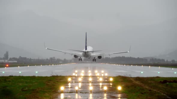 The plane approaches and lands early in the morning at the airport in evening