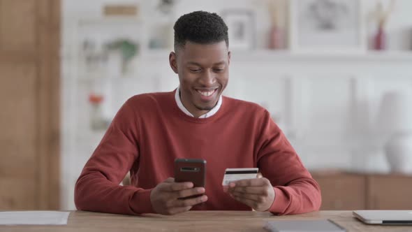 African Man making Online Payment Success on Smartphone